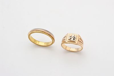 two gold rings with a cross on each side and a cross on the other