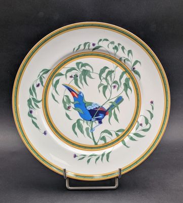 a close up of a plate with a bird painted on it