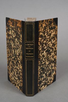 the front cover of a book with a black and gold cover