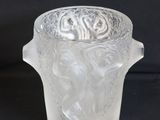 a glass vase with a handle on a black background