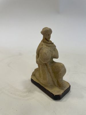 an image of a statue of a man sitting on top of a table