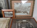 many framed pictures on the wall of this room