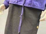 a mannequin wearing a purple jacket and black pants
