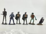 a group of star wars action figures sitting on top of a white surface