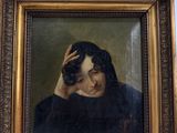 portrait of a man holding a camera in a gold frame