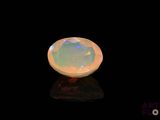 a white oplite stone on a black surface