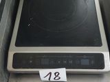 a stove that has a black burner on top of it