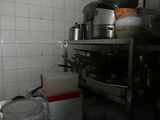 pots and pans on a shelf in a kitchen