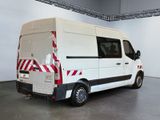 a white van with red and white stripes parked in a garage