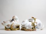 two figurines of birds sitting on top of each other