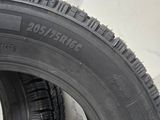 tire treads of a car are lined up against a wall