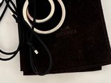 a black bag with a silver ring on top of it