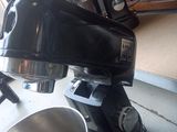 a black mixer sitting next to a bowl on a counter
