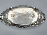 an antique silver plate with a decorative design on it