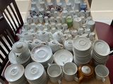 a table with a lot of dishes and cups on it