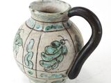 a vase with a handle that has a frog on it