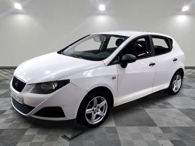 a picture of a white car parked in a garage