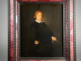 portrait of a young man in a black dress with a red frame