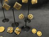 a group of gold and silver jewelry on a black surface