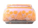 a glass vase with orange flowers on it on a white background