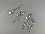 five spoons and two spoons sitting on a table