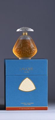 an image of a bottle of perfume sitting on top of a blue box