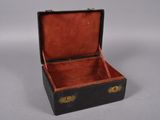 an old black and red suitcase with gold handles on a white surface