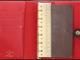 an image of a red wallet with a ruler in it