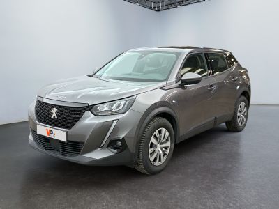 the grey car is parked in a large room with a black floor