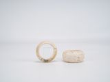 two pieces of white stone sitting next to each other on a white surface