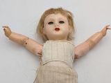a doll that is laying on the floor with its arms spread out