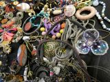 a pile of assorted jewelry on a black table
