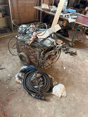 a pile of junk in a garage with a lot of tools