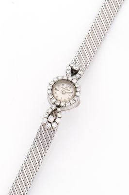 a close up of a watch on a white surface with a white background