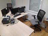 an image of a desk with two computer monitors and a chair