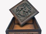 une image représentant une boîte en bois ornée d'un motif sculpté