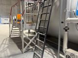 a large tank with a ladder in the middle of it