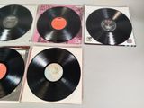 three black vinyl records sitting on top of a table next to each other