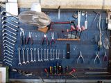 many tools hanging on the wall in the garage