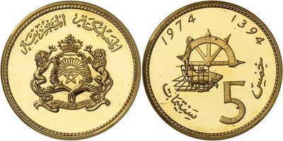 a close up of two gold coins with arabic writing on them