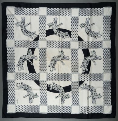 an image of a black and white quilt with a picture of a cat