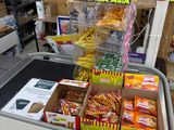 boxes of candy and candy bars are on display in a store