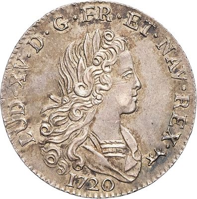 a silver coin with a woman ' s head and long hair