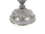 a silver candle holder on a white background