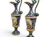pair of blue and gold vases with a painting of a man and a woman on them