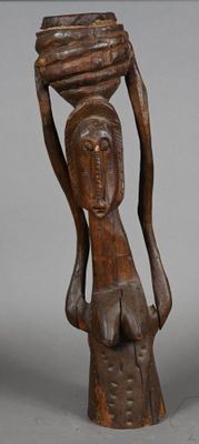 wooden statue of a woman carrying a bowl on her head