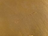 a close up of a brown leather bag with writing on it