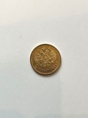 an image of a gold coin sitting on top of a white surface