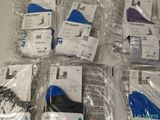 several pairs of shoes are wrapped in plastic bags on a table