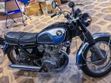 a blue motorcycle that is on display in a room